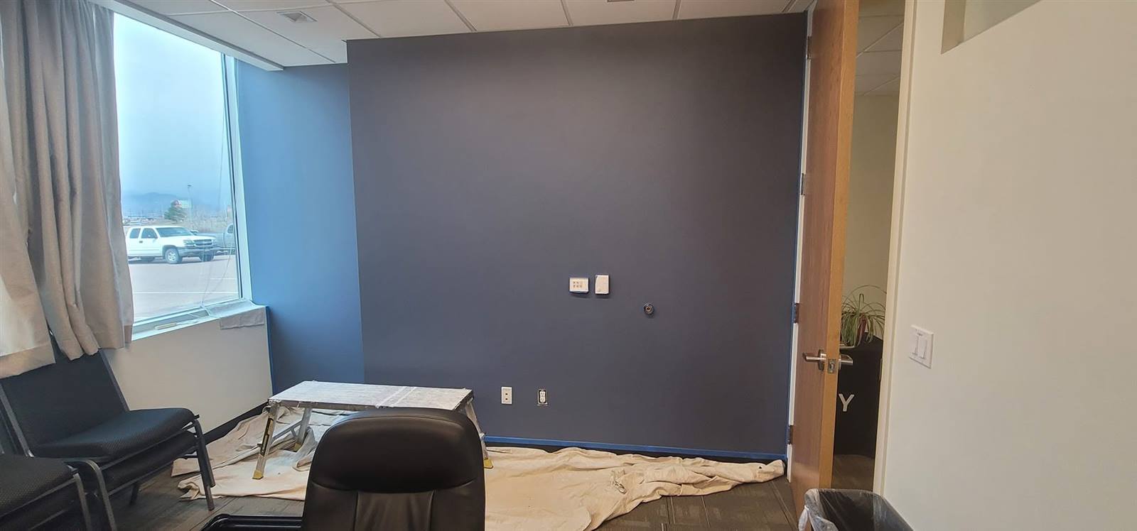 Commercial office repainted with navy accent wall